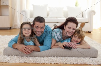 Smiling family on floor in living-room