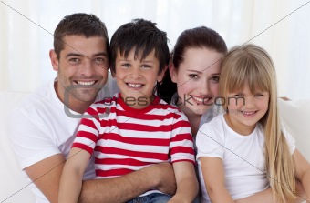 Portrait of family sitting on sofa together