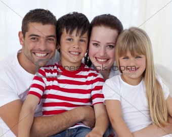 Portrait of happy family sitting on sofa together