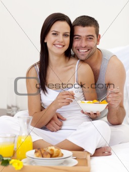 Couple having healthy breakfast in bed