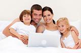Family buying online in bed