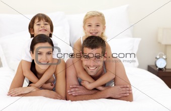 Family having fun in parent's bed