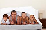 Happy family under the sheets