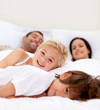 Family realxing in parent's bed