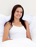 Smiling woman sitting in bed
