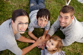 Smiling family relaxing in a garden