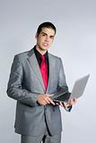 Businessman in gray suit holding laptop