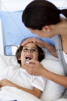 Portrait of mother taking her son's temperature