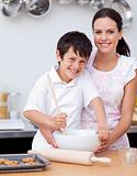 Boy baking with his mother in the kitchen