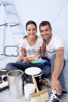 Couple with colour samples to paint new appartment
