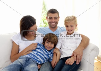 Playful family sitting on sofa at home
