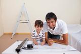 Father and son drawing architectural plans