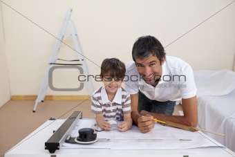 Father and son drawing architectural plans