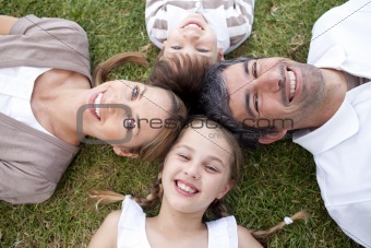 Smiling family lying outdoors