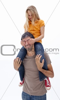 Dad giving girl piggyback ride with closed eyes