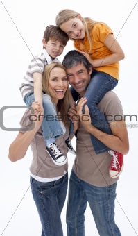 Mother and father giving children piggyback ride
