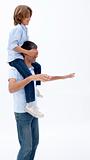 Man giving son piggyback ride with eyes closed
