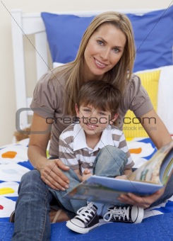 Attractive mother reading a book with her son