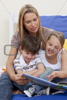 Mother reading a book with her daughter and son