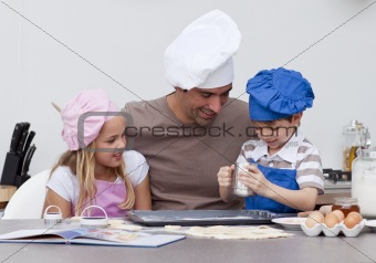 Father and children baking in the kitchen