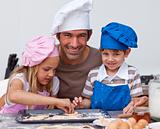 Father and daughter and son baking in the kitchen