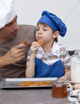 Father and son eating cookies