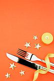 knife and fork with ribbon, stars, candle