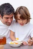 Portrait of dad and boy having breakfast together