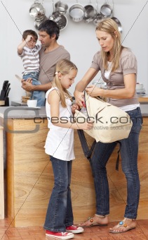 Mother and daughter preparing the bag for school