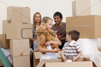 Family in new house unpacking boxes