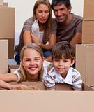 Portrait of children unpacking boxes with their parents