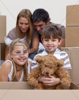 Little boy and girl moving house with parents