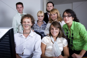 Young group of people smiling while watching at the screen
