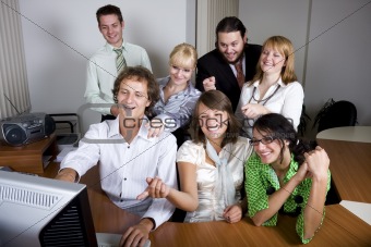 Young people laughing and pointing at the computer screen