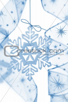Christmas decoration with snowflake and ribbons / blue colored