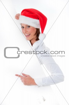 Female Santa pointing down at blank billboard