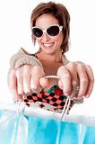 Happy young woman with shopping bags on white