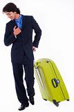 Corporate man looking down with is luggage