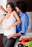 playful young couple enjoying their love in kitchen