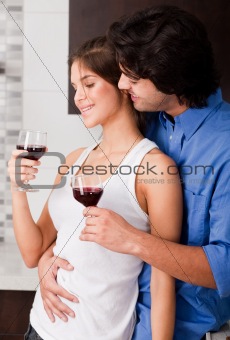 young couple toasting at kitchen
