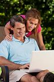 Happy Middle Aged Man and Woman Couple Using Laptop Computer