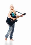 Teenage girl playing an acoustic guitar wearing jeans isolated on white