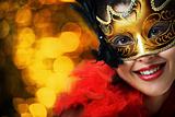 Beautiful young woman in carnival mask