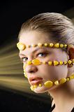 yellow necklace around face