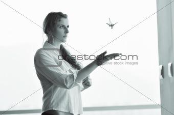 young woman throwing home keys in air