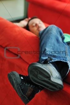 man relaxing on sofa 