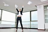 young business woman throw papers in air
