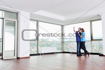 happy couple in empty apartment