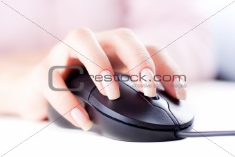 Female hand on computer mouse