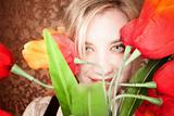 Pretty young blonde woman with plastic flowers